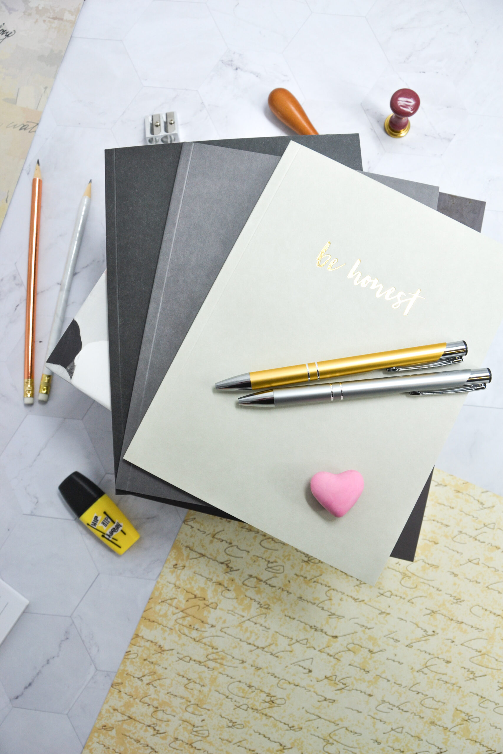 stack of journals with be honest written on cover