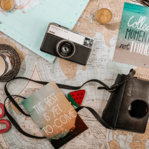 Flatlay with map, camera and other travel items