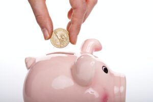 Piggie bank with a coin dropping in