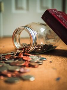 Jar of coins spilling out