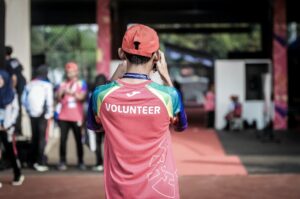 Person with Volunteer written on shirt taking a picture