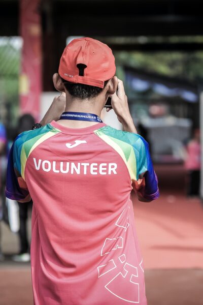 Person with Volunteer written on shirt taking a picture
