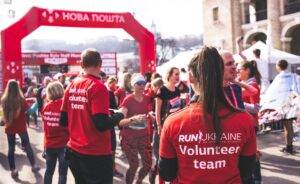 people wearing red volunteering at a race