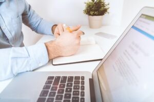 desk with doctor writing to decide on a health insurance plan