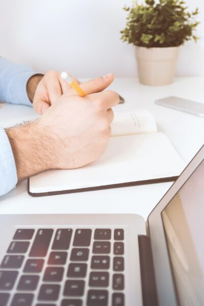 desk with doctor writing to decide on a health insurance plan