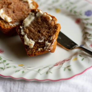close up of applesauce muffin with butter