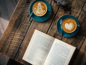 reading book with 2 coffees