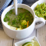 bowl of Chicken Tortilla soup with guac and lime