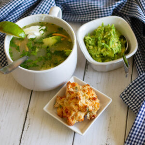 bowl of Chicken Tortilla soup with guac and biscuit