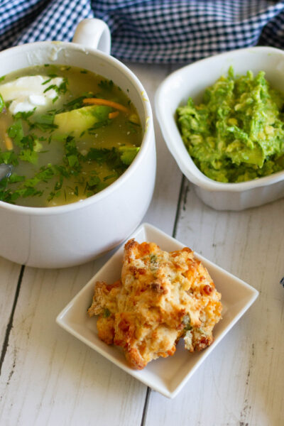 bowl of Chicken Tortilla soup with guac and biscuit