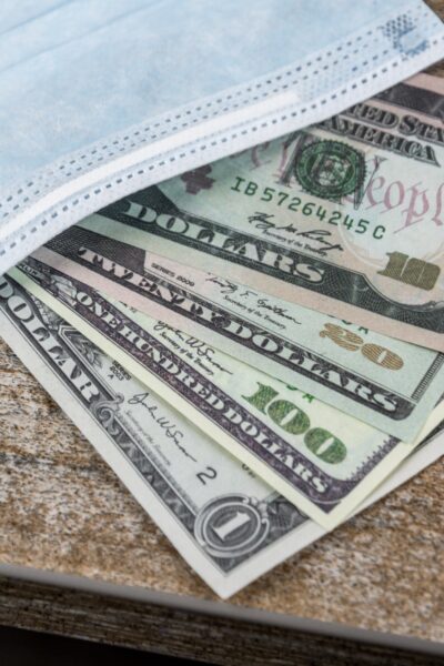 US Dollar bills with medical mask