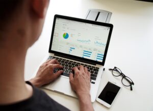 Close up of laptop screen with graphs and info on it