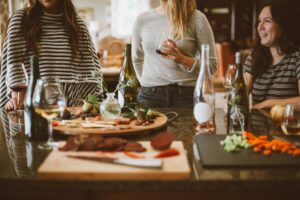 Friends with dishes from dinner enjoying themselves
