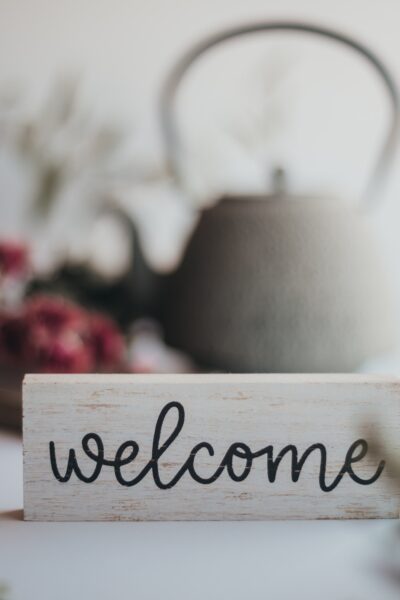 welcome sign with teapot in background