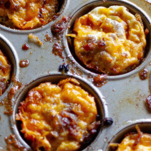 close up of hash brown egg nests in muffin tin