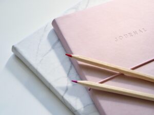 Journals on desk, pink and white