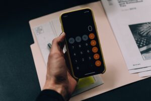 phone calculator showing zero with papers in background