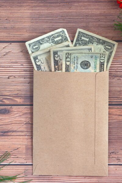 envelope with money sticking out sitting on desk