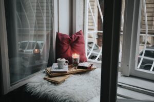 coffee and candle on seat with pillow
