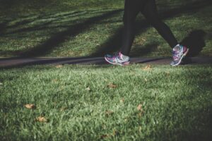 feet running on path through grass