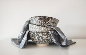 grey patterned bowls stacked with towels
