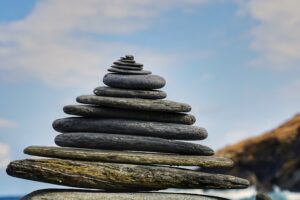 rocks balanced in a stack with sky in background