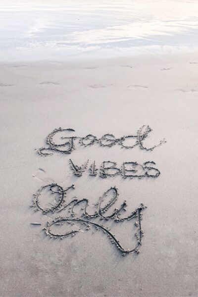 Good Vibes Only written in sand on beach