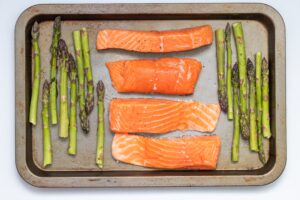 Salmon and Asparagus cooking on a sheet pan