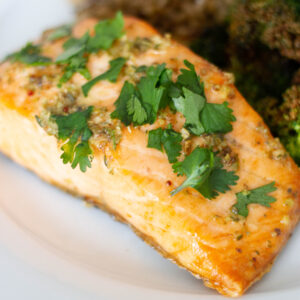 Close up picture of Air Fryer Salmon with herbs on top.