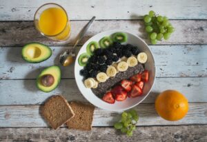 bowl of cut fruit on a white rustic background