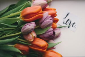 tulips bouquet laying down on paper saying love.