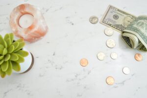 desk with coins, dollar bills, and other decorations