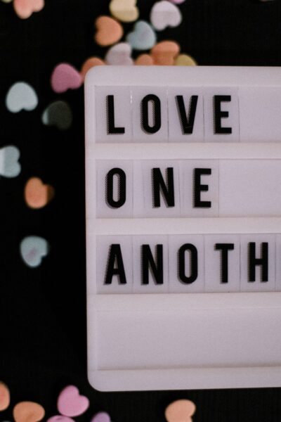 letter sign saying "love one another"