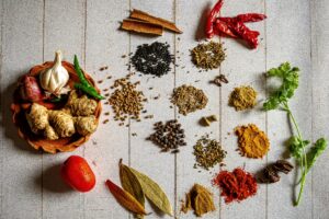 small piles of spices on a white backdrop