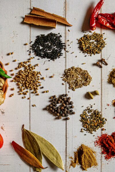 small piles of spices on a white backdrop
