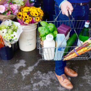 grocery shopping at the market with a wire basket