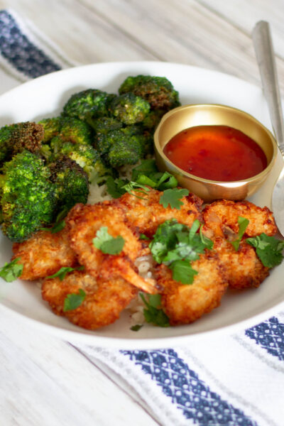 Close up plate of air fryer frozen coconut shrimp, broccoli, and white rice.