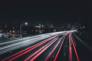 blurry shot of headlights driving in dark on freeway