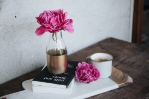 pink flowers in a vase on a desk