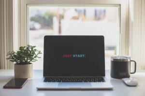 Laptop open to a screen that says Just Start