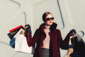 stylish woman holding shopping bags.