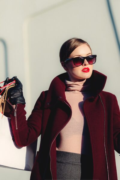stylish woman holding shopping bags.