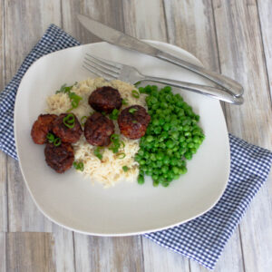 Air Fryer Meatballs with rice and peas on a plate
