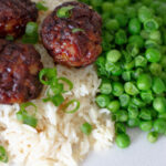 Air Fryer Meatballs with rice and peas on a plate