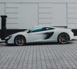 white lamborghini parked on cobblestone street